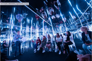 Attendees participating in an immersive, light-filled session at C2 Montréal, illustrating the event’s blend of conference, festival, and participatory experience that drives attendee connection and retention.